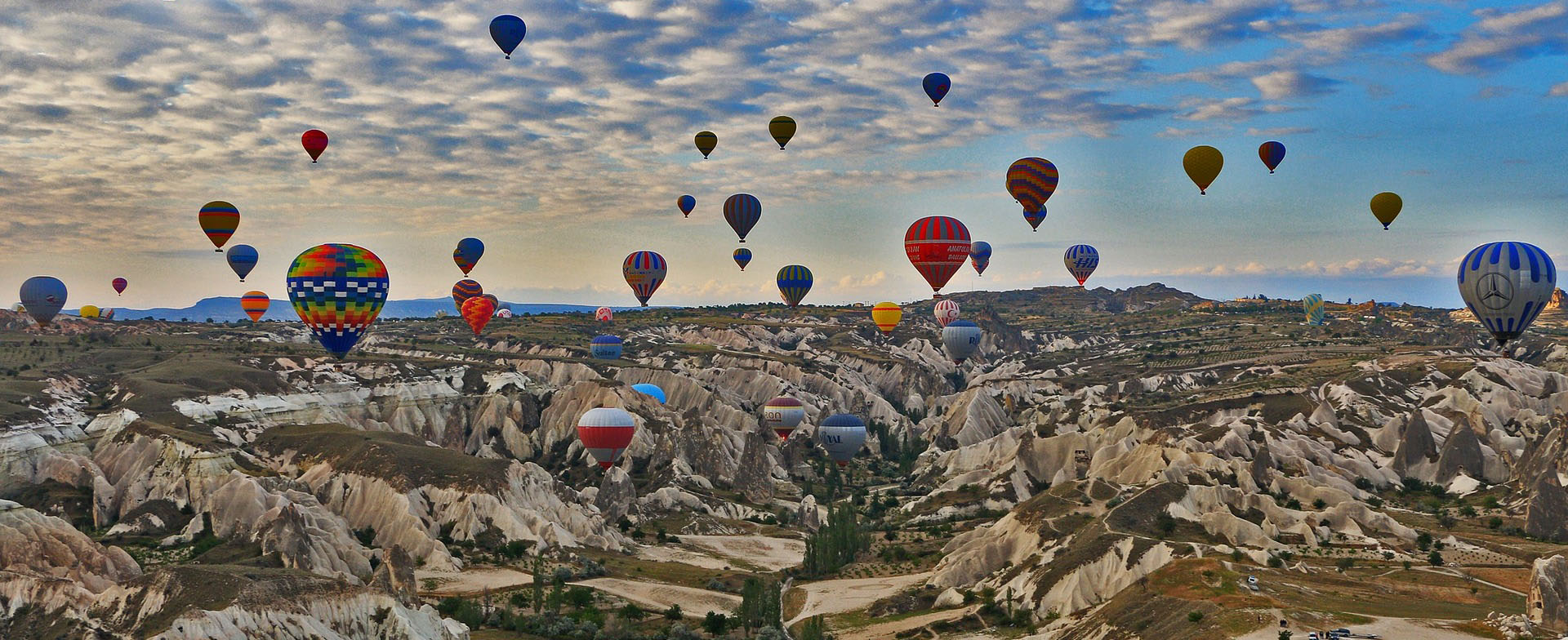 Hot-air balloons above Cappadocia valleys at sunrise