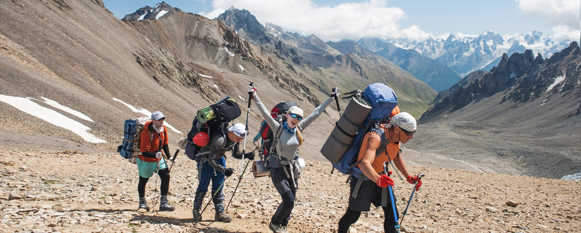 Hikers crossing a rocky mountain slope in the Caucasus