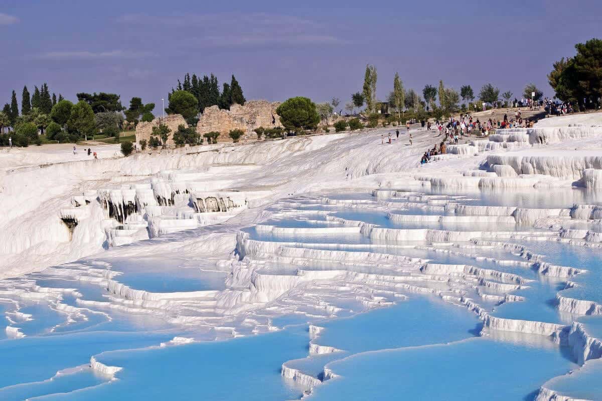 White Pamukkale travertine terraces and blue thermal pools